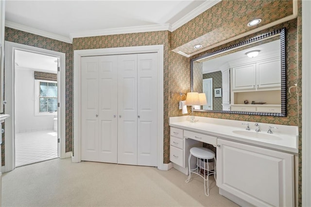 bathroom with ornamental molding and vanity