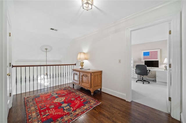 sitting room featuring ornamental molding, dark hardwood / wood-style flooring, and vaulted ceiling