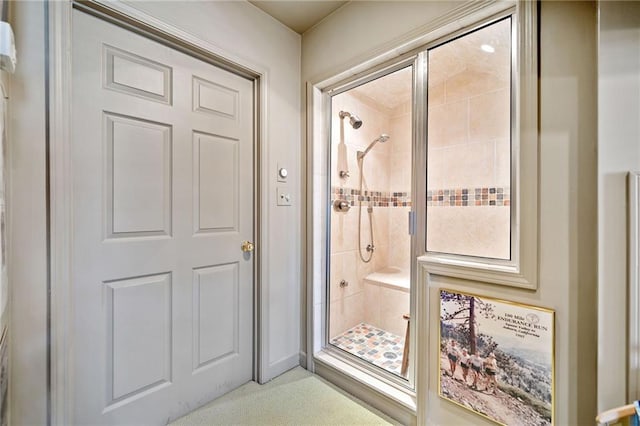 interior space featuring a shower with door