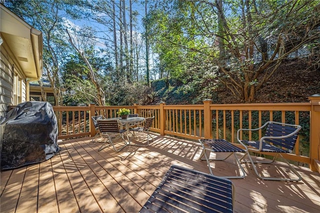 wooden terrace featuring a grill