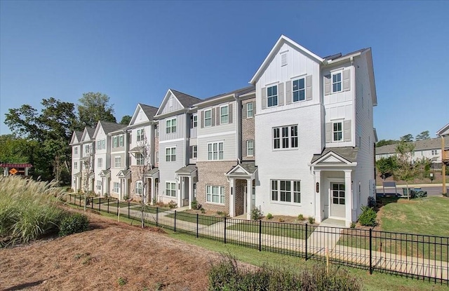 view of property featuring a front lawn