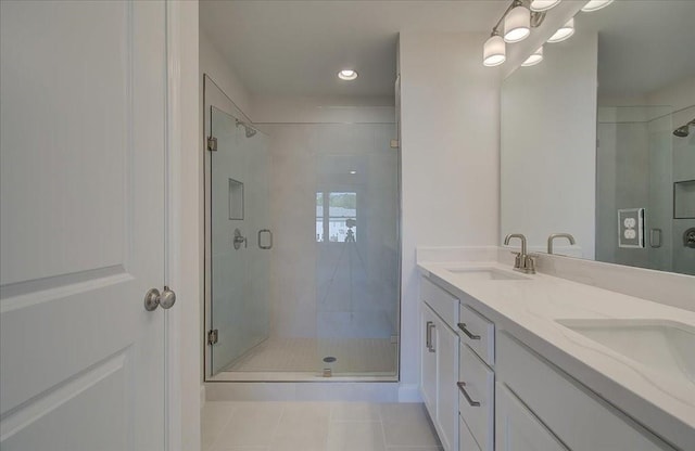 bathroom featuring vanity, tile patterned flooring, and a shower with door