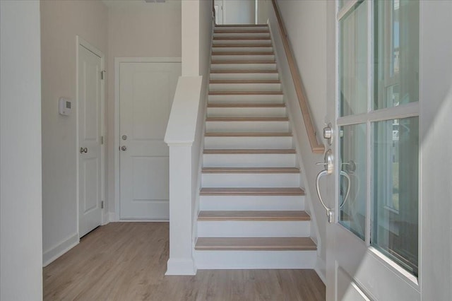 staircase with hardwood / wood-style floors