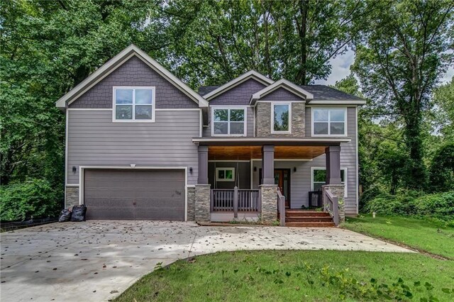 view of front of property featuring a porch and a garage