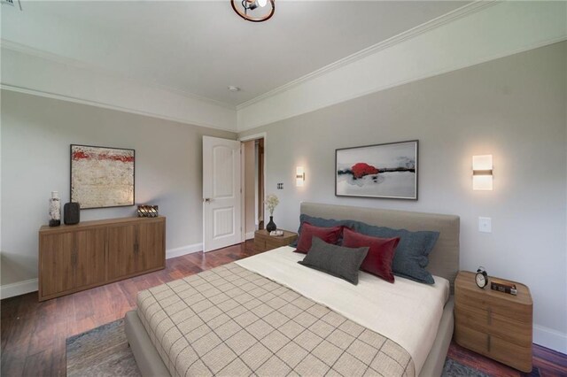 bedroom featuring ornamental molding and hardwood / wood-style flooring