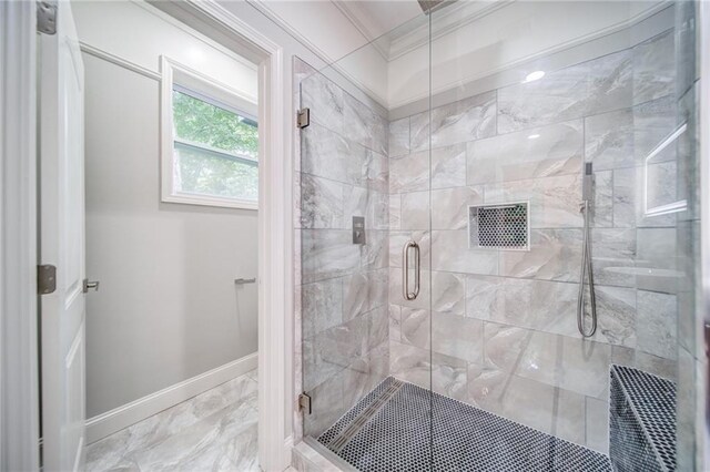 bathroom featuring a shower with shower door and ornamental molding