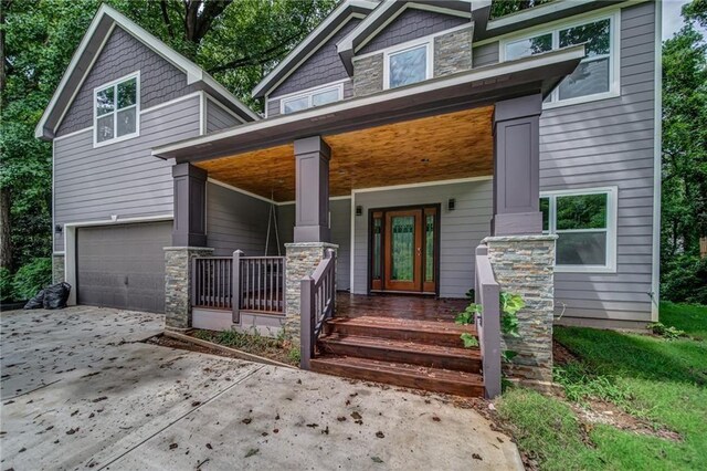 view of front facade with covered porch and a garage