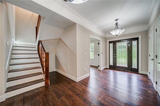 entrance foyer with dark hardwood / wood-style floors and ornamental molding