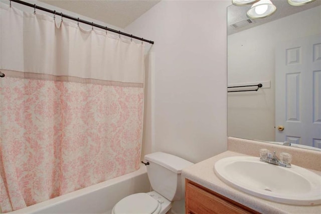 bathroom featuring visible vents, toilet, vanity, shower / tub combo, and a textured ceiling