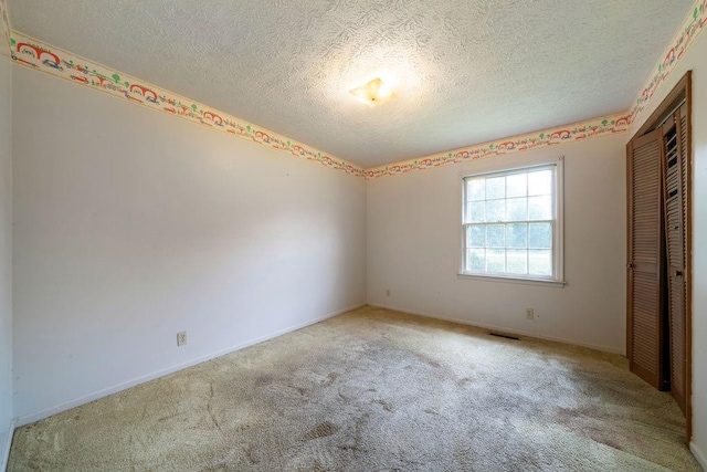 101 Beaver Run, Lagrange, GA 30241 - unfurnished bedroom with carpet floors, a textured ceiling, and a closet