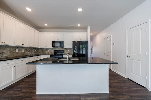 8475 Douglass Trl, Jonesboro, GA 30236 - kitchen with black appliances, a kitchen island with sink, visible vents, decorative backsplash, and a sink