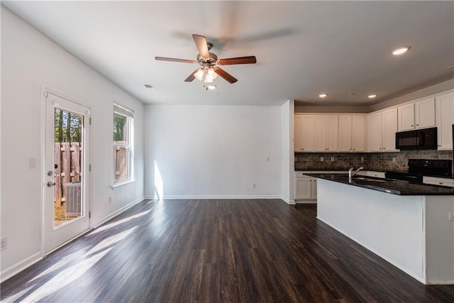 8475 Douglass Trl, Jonesboro, GA 30236 - kitchen with backsplash, dark wood-style flooring, a ceiling fan, and black appliances