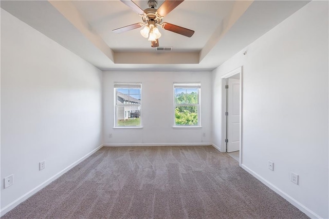 8475 Douglass Trl, Jonesboro, GA 30236 - carpeted spare room with a tray ceiling, ceiling fan, visible vents, and baseboards