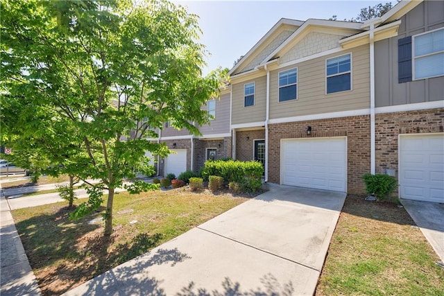 8475 Douglass Trl, Jonesboro, GA 30236 - townhome / multi-family property with brick siding, an attached garage, board and batten siding, and concrete driveway
