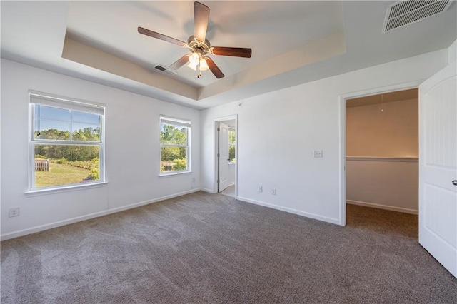 8475 Douglass Trl, Jonesboro, GA 30236 - unfurnished bedroom with visible vents, baseboards, and a tray ceiling