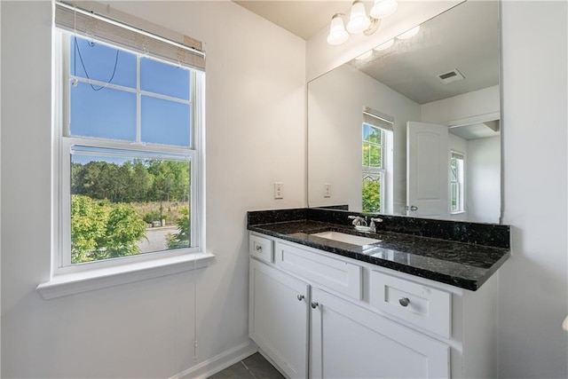8475 Douglass Trl, Jonesboro, GA 30236 - bathroom with vanity, baseboards, and visible vents