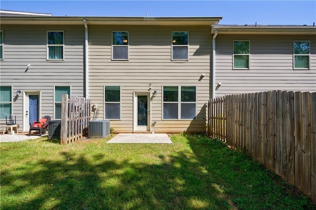 8475 Douglass Trl, Jonesboro, GA 30236 - back of house featuring central AC, fence, a patio, and a lawn
