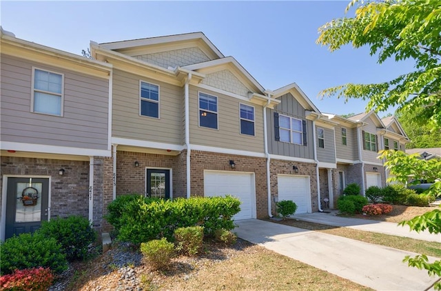8475 Douglass Trl, Jonesboro, GA 30236 - townhome / multi-family property with an attached garage, board and batten siding, driveway, and brick siding