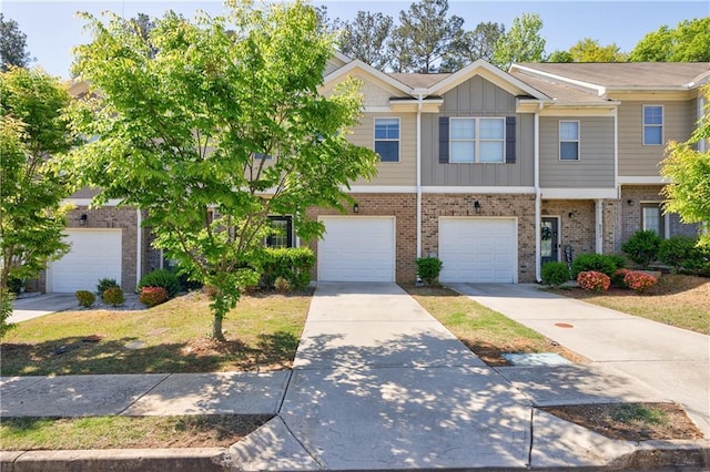 8475 Douglass Trl, Jonesboro, GA 30236 - multi unit property featuring an attached garage, board and batten siding, concrete driveway, and brick siding