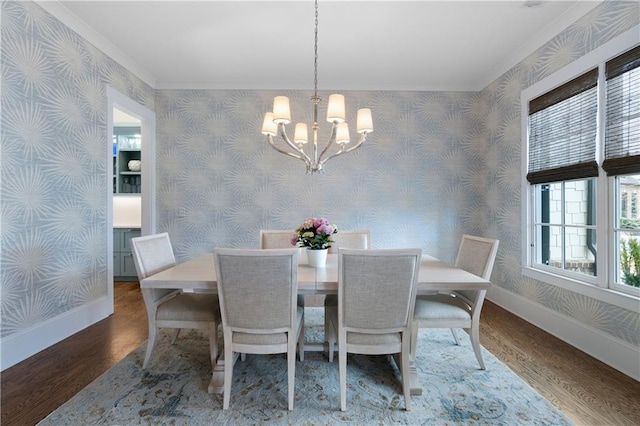 dining space with baseboards, an inviting chandelier, wood finished floors, and wallpapered walls