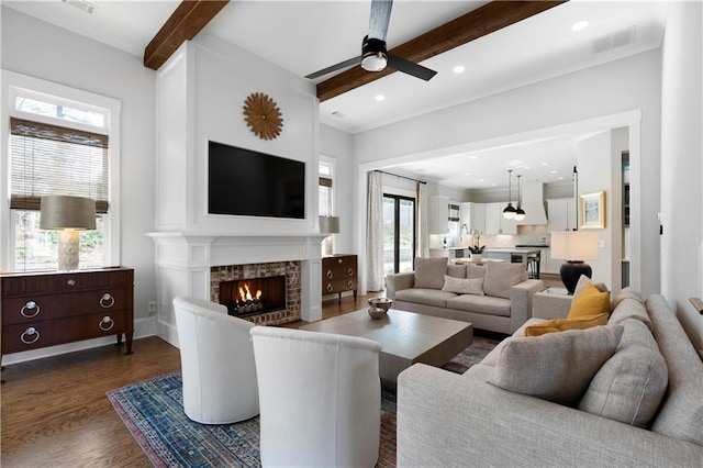 living room with visible vents, beamed ceiling, dark wood finished floors, recessed lighting, and ceiling fan
