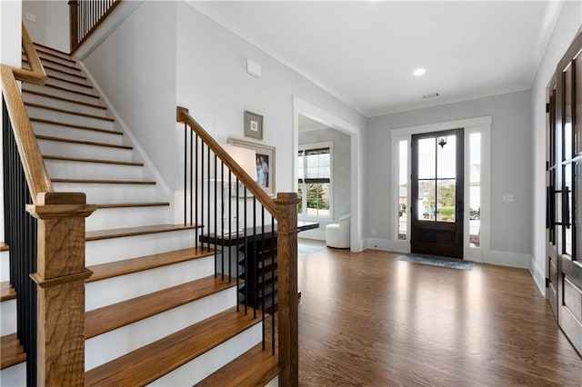 entryway featuring wood finished floors, recessed lighting, crown molding, baseboards, and stairs