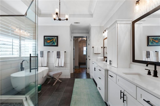 full bath featuring visible vents, double vanity, a freestanding tub, a sink, and a raised ceiling