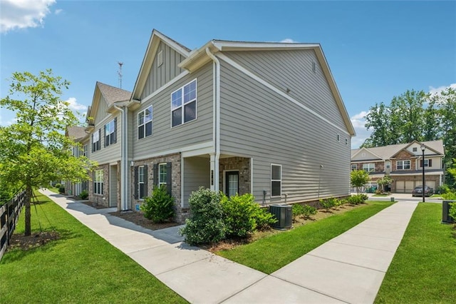 6761 Cedar Glen Rd, Peachtree Corners, GA 30360 - view of home's exterior featuring board and batten siding and a yard