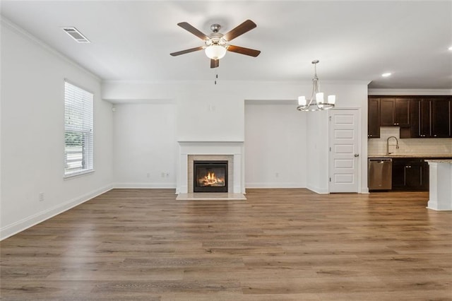 6761 Cedar Glen Rd, Peachtree Corners, GA 30360 - unfurnished living room with ornamental molding, a glass covered fireplace, ceiling fan, a chandelier, and recessed lighting