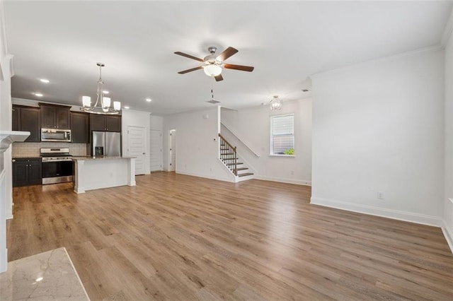 6761 Cedar Glen Rd, Peachtree Corners, GA 30360 - unfurnished living room with stairs, a ceiling fan, light wood-style floors, recessed lighting, and ornamental molding