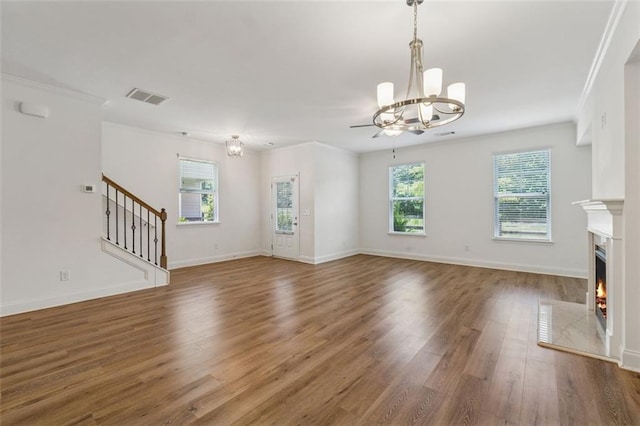 6761 Cedar Glen Rd, Peachtree Corners, GA 30360 - unfurnished living room with a chandelier, a fireplace, wood finished floors, stairs, and ornamental molding