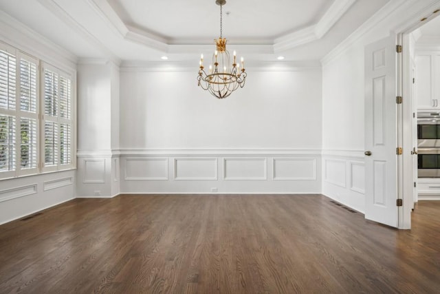 unfurnished room with dark hardwood / wood-style flooring, a raised ceiling, and a notable chandelier