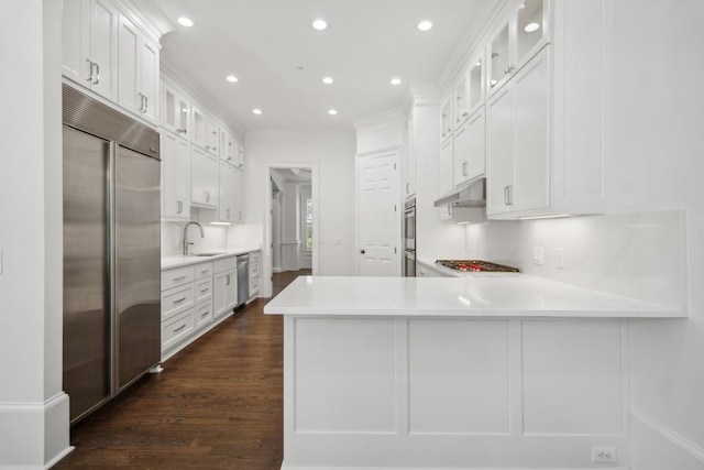 kitchen featuring white cabinetry, appliances with stainless steel finishes, and kitchen peninsula