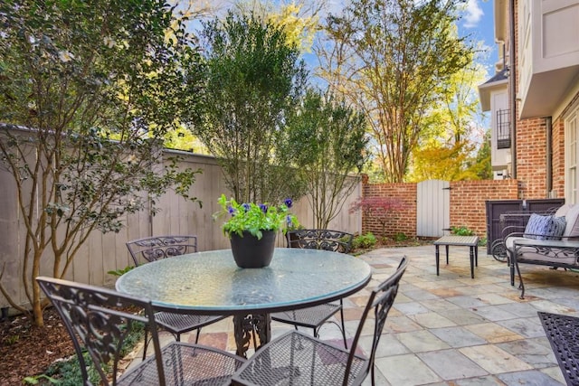 view of patio with outdoor dining area and a fenced backyard