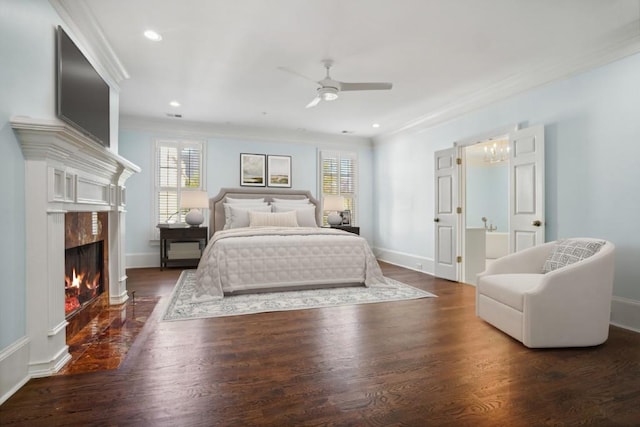 bedroom with a premium fireplace, dark hardwood / wood-style floors, ceiling fan, and crown molding