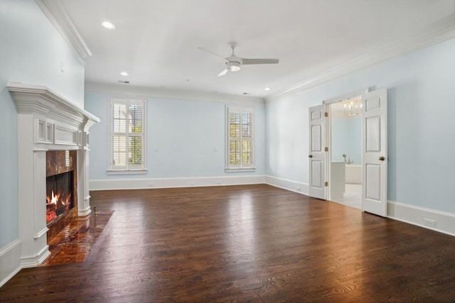 unfurnished living room with ceiling fan, dark wood-type flooring, a fireplace, and a healthy amount of sunlight