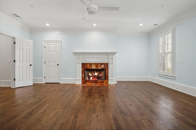 unfurnished living room with a tile fireplace, ornamental molding, dark hardwood / wood-style floors, and ceiling fan