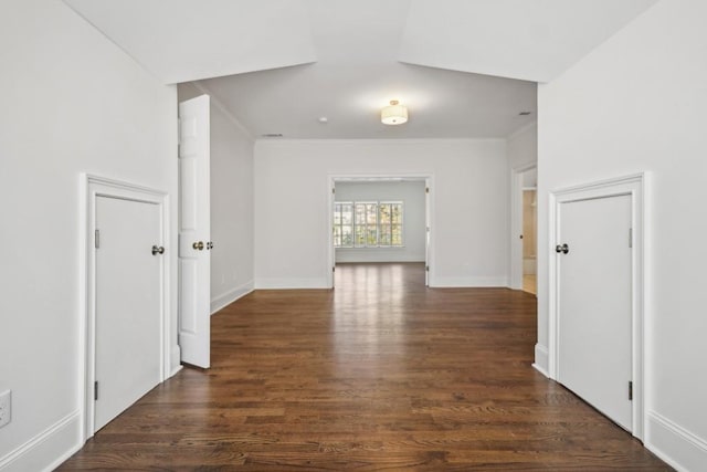 spare room featuring dark hardwood / wood-style flooring and ornamental molding