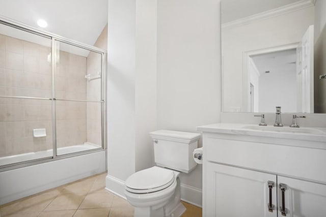 full bathroom featuring tile patterned flooring, vanity, toilet, and combined bath / shower with glass door