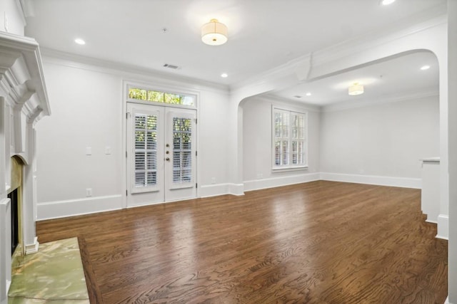 unfurnished living room featuring ornamental molding, plenty of natural light, and dark wood-type flooring