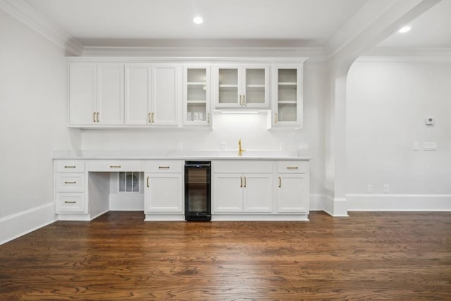 bar featuring wine cooler, dark hardwood / wood-style flooring, sink, and white cabinets