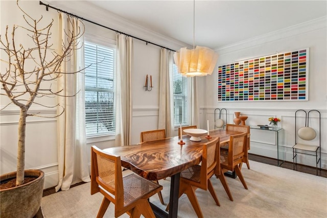 dining space with crown molding and a healthy amount of sunlight