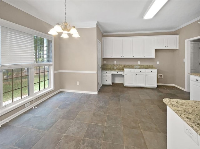 kitchen featuring a chandelier, decorative light fixtures, light stone counters, ornamental molding, and white cabinetry