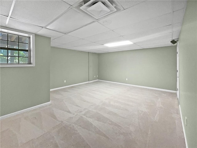 basement with a drop ceiling and carpet