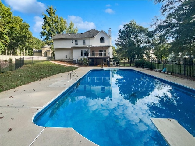 view of pool featuring a yard, a diving board, and a patio area