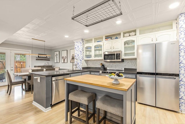 114 Emily Ln, Alpharetta, GA 30009 - kitchen featuring appliances with stainless steel finishes, butcher block counters, a sink, a peninsula, and light wood-type flooring