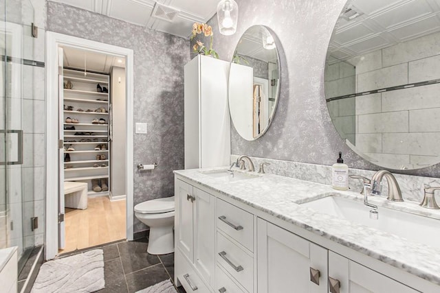 114 Emily Ln, Alpharetta, GA 30009 - full bathroom featuring double vanity, a walk in closet, a stall shower, toilet, and an ornate ceiling