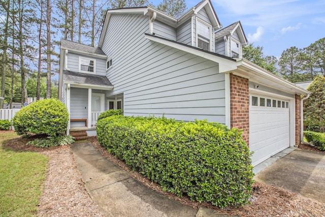 114 Emily Ln, Alpharetta, GA 30009 - view of side of home featuring driveway, a garage, and brick siding