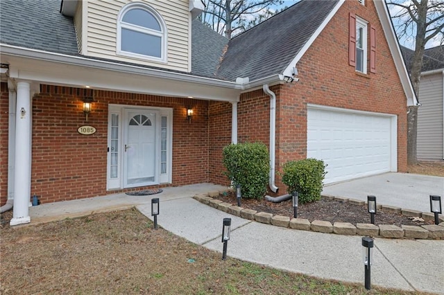 view of exterior entry with a garage