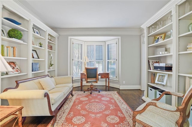 sitting room featuring ornamental molding, baseboards, and wood finished floors